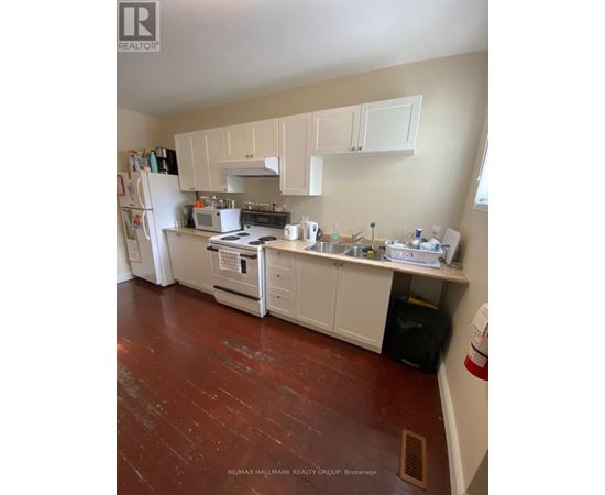 A kitchen with white appliances and cabinets.
