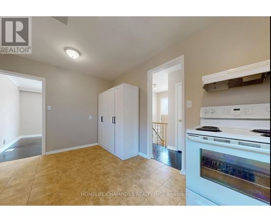 A kitchen area with a stove top oven and cabinets.