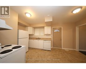 A small kitchen with white appliances and cabinets.