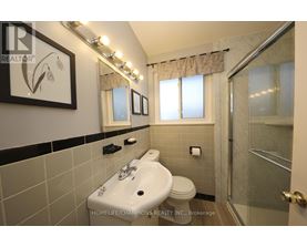 A bathroom with a sink, toilet, and shower.
