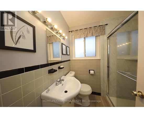 A bathroom with a sink, toilet, and shower.
