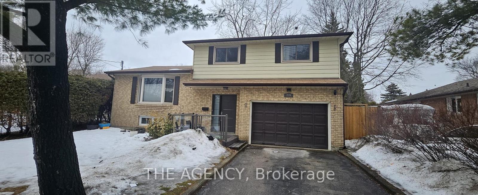 A house with a garage is for sale.
