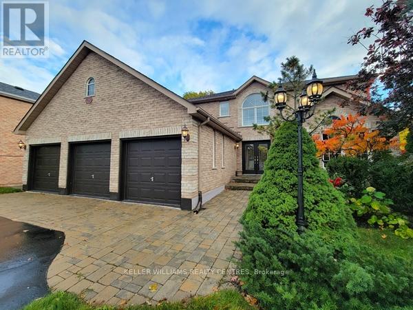 A house with a brick facade and a driveway in front.