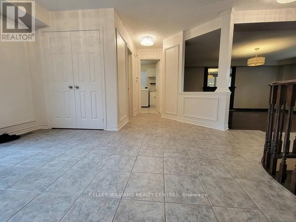 A spacious room with a white door and a mirror on the wall.