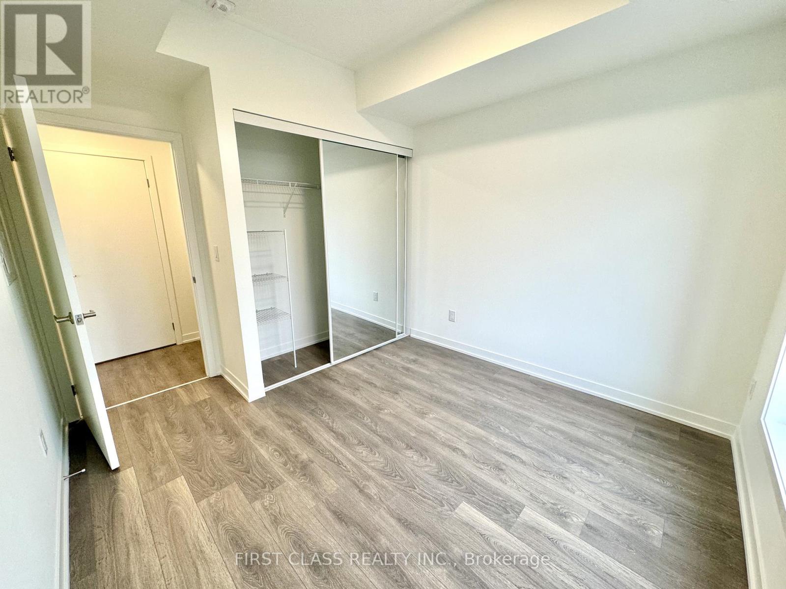 A room with a wooden floor and white walls.