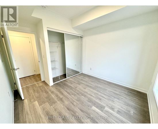 A room with a wooden floor and white walls.