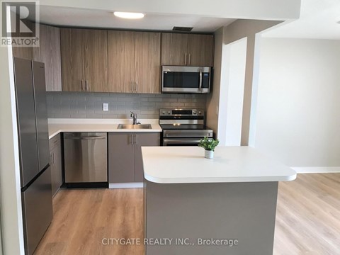 A kitchen with a white counter top and wooden cabinets.