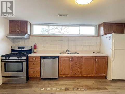 A kitchen with wooden cabinets and a white refrigerator.
