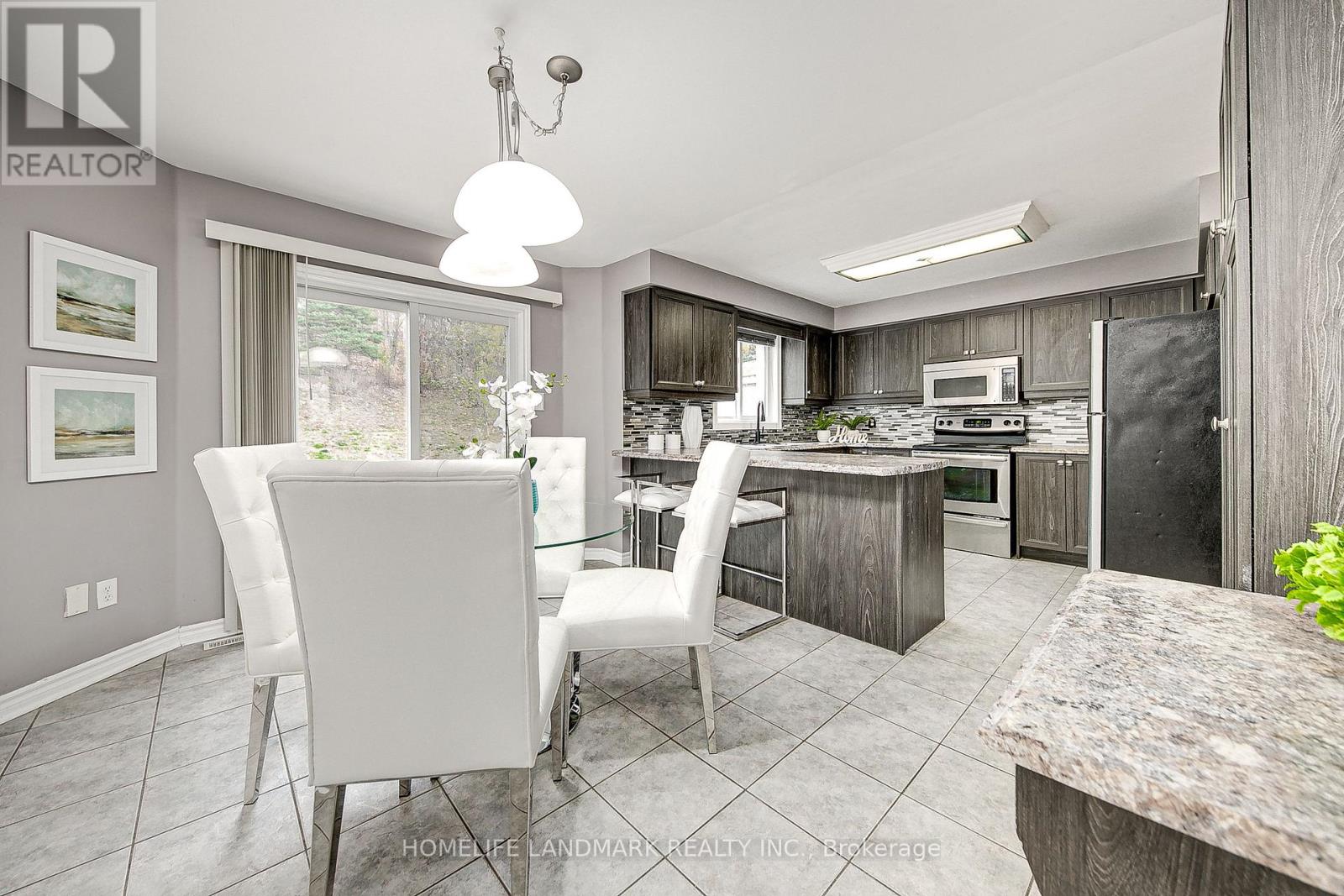 A modern kitchen with a dining table and chairs.