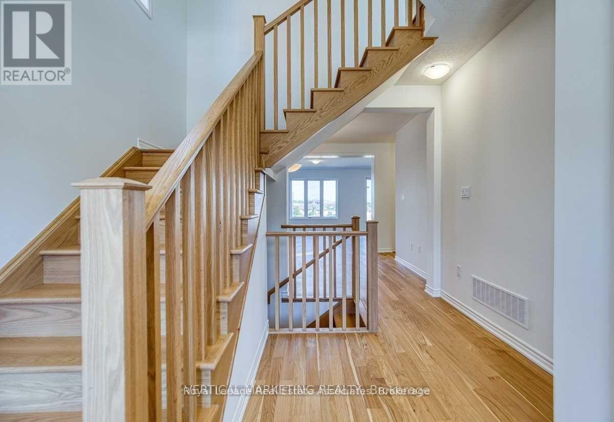 A wooden staircase with a white wall on the side.