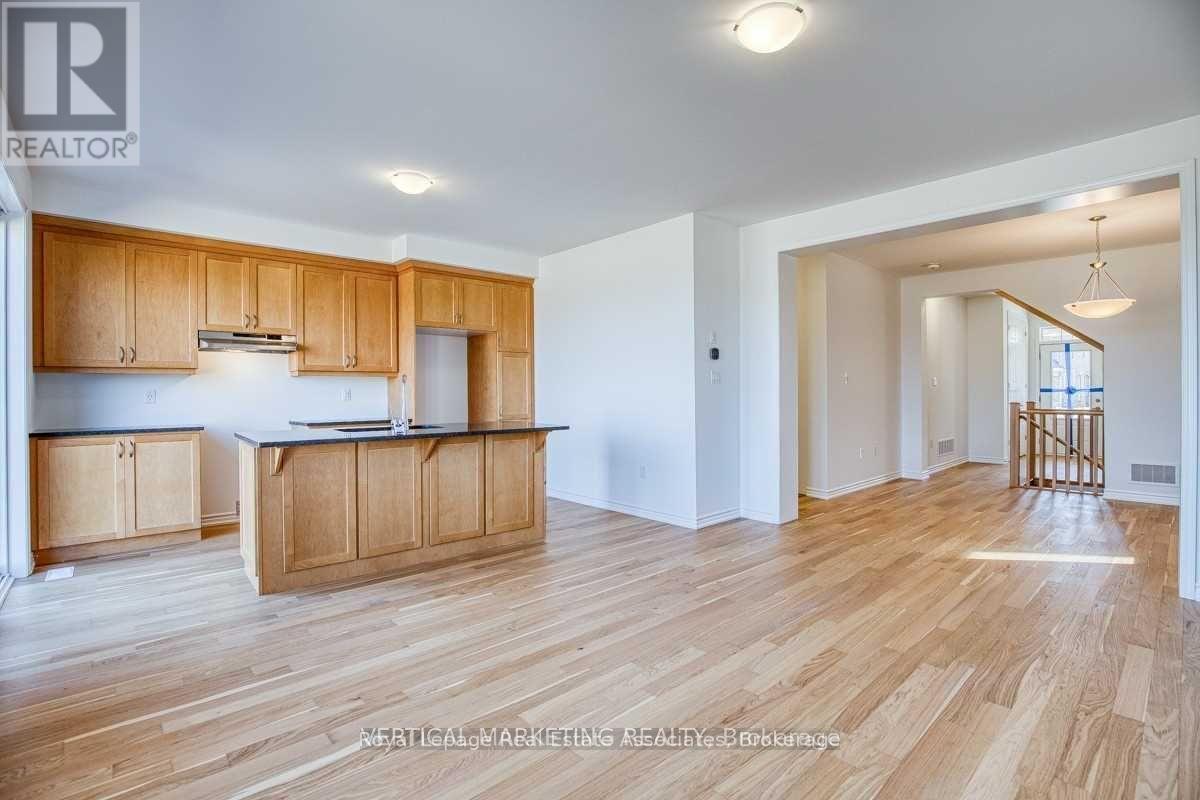 A well-lit kitchen with wooden cabinets and a large island.