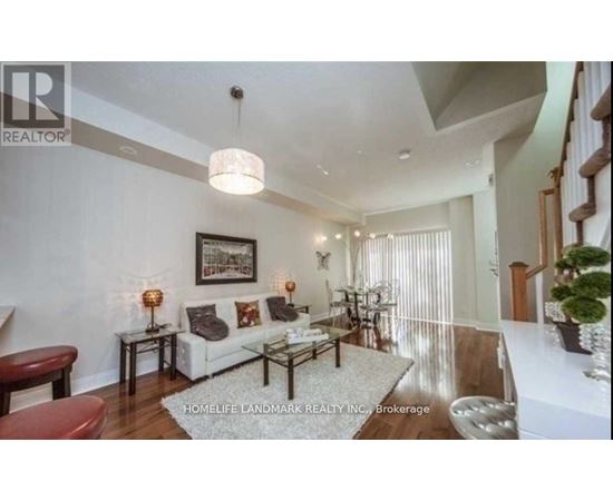 A well-lit living room with a white sofa and a coffee table.