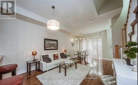 A well-lit living room with a white sofa and a coffee table.