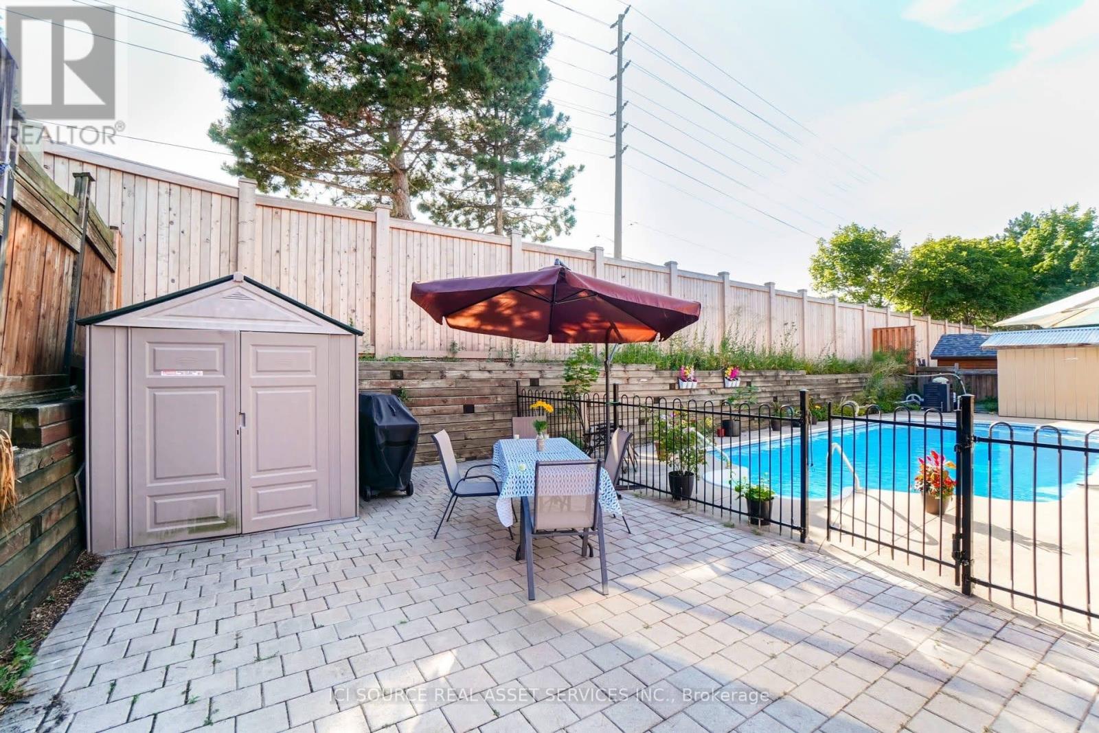 A backyard with a pool and a small gazebo.