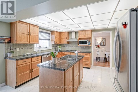A kitchen with wooden cabinets and granite countertops.