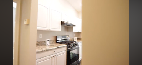 A kitchen with a black stove top oven.