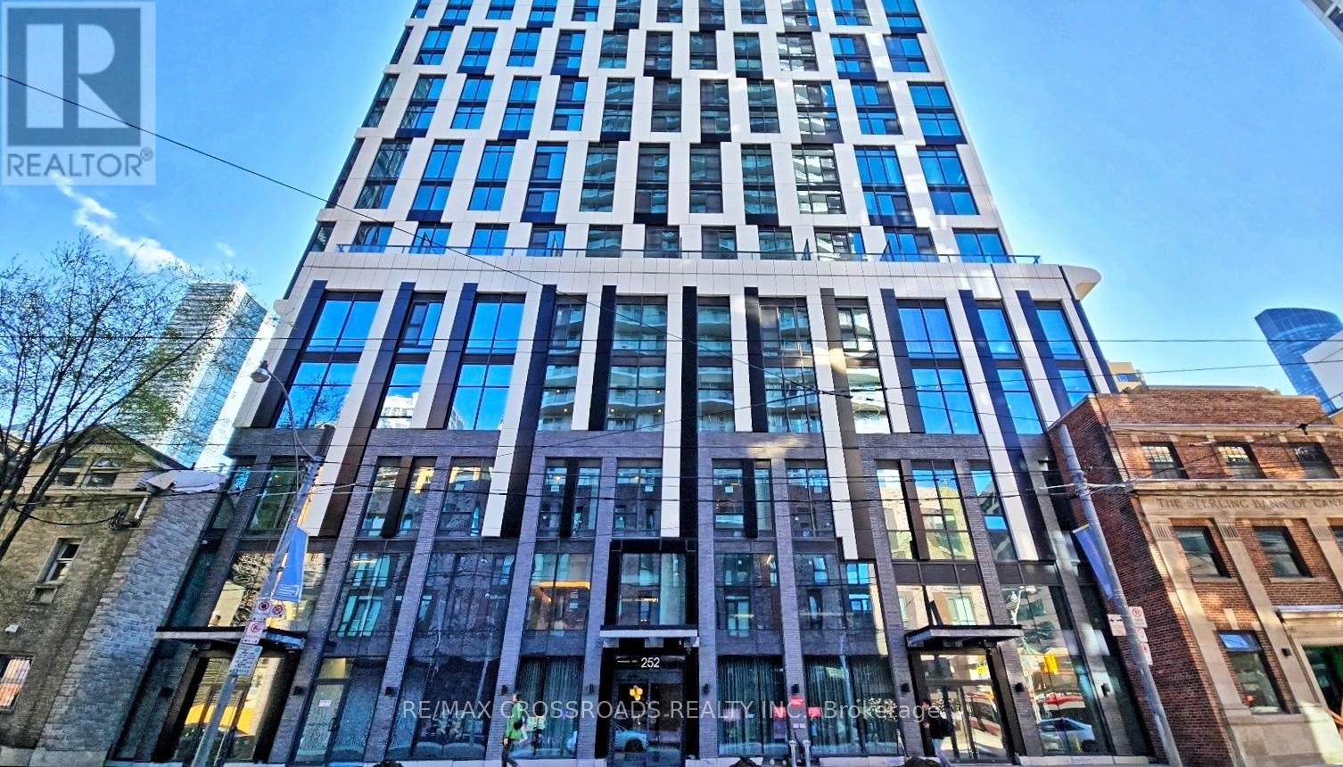 A tall building with many windows is being advertised for rent by RE/MAX.