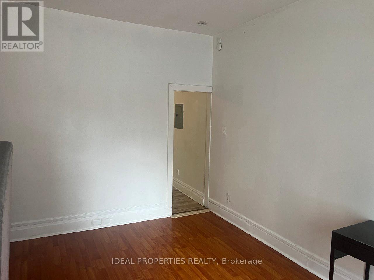 A room with a wooden floor and white walls.