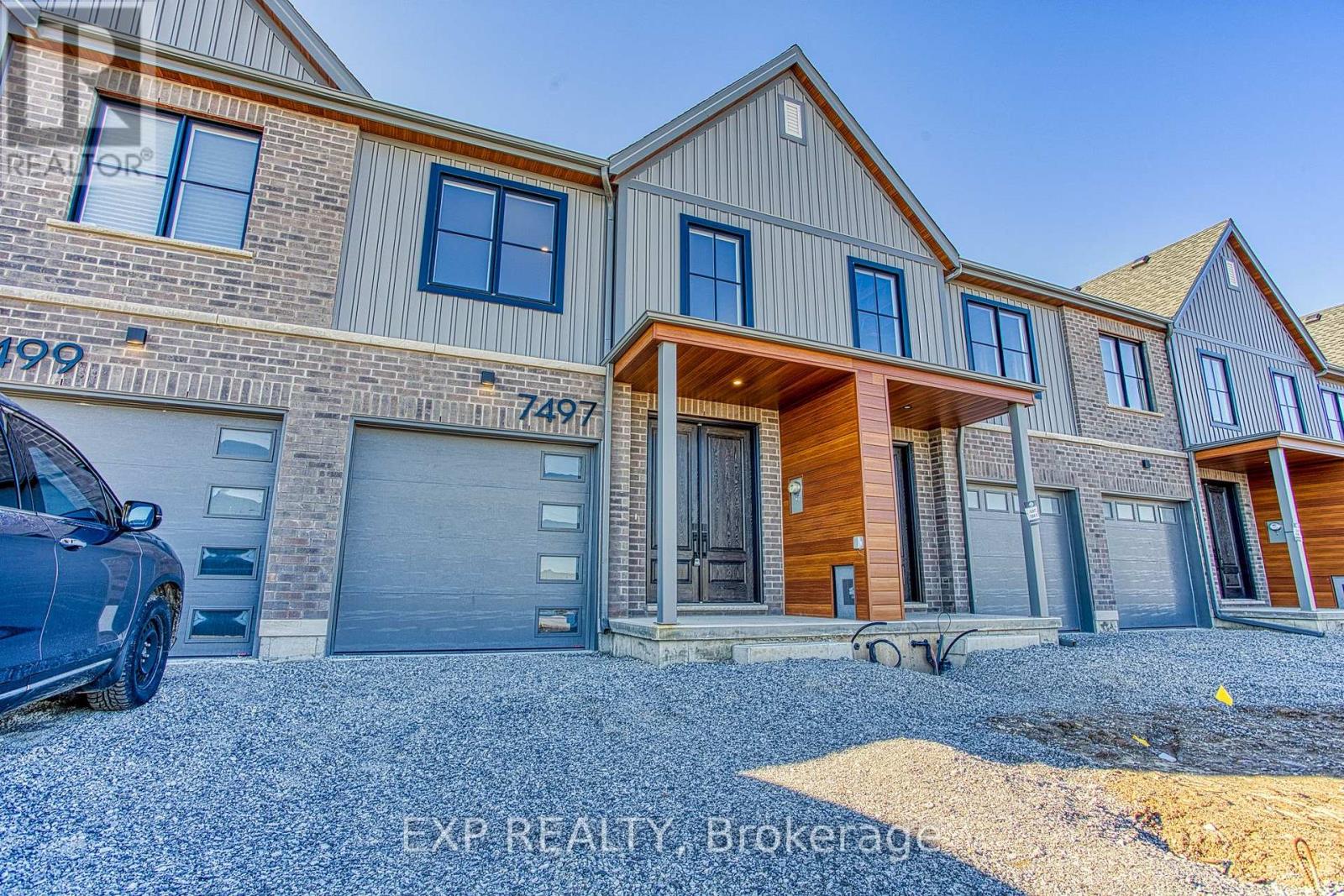 A modern two-story house with a garage is for sale.