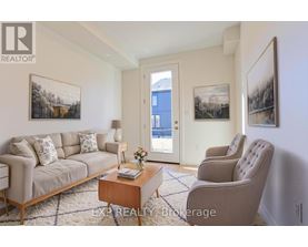 A living room with a couch, chair, and pictures on the wall.