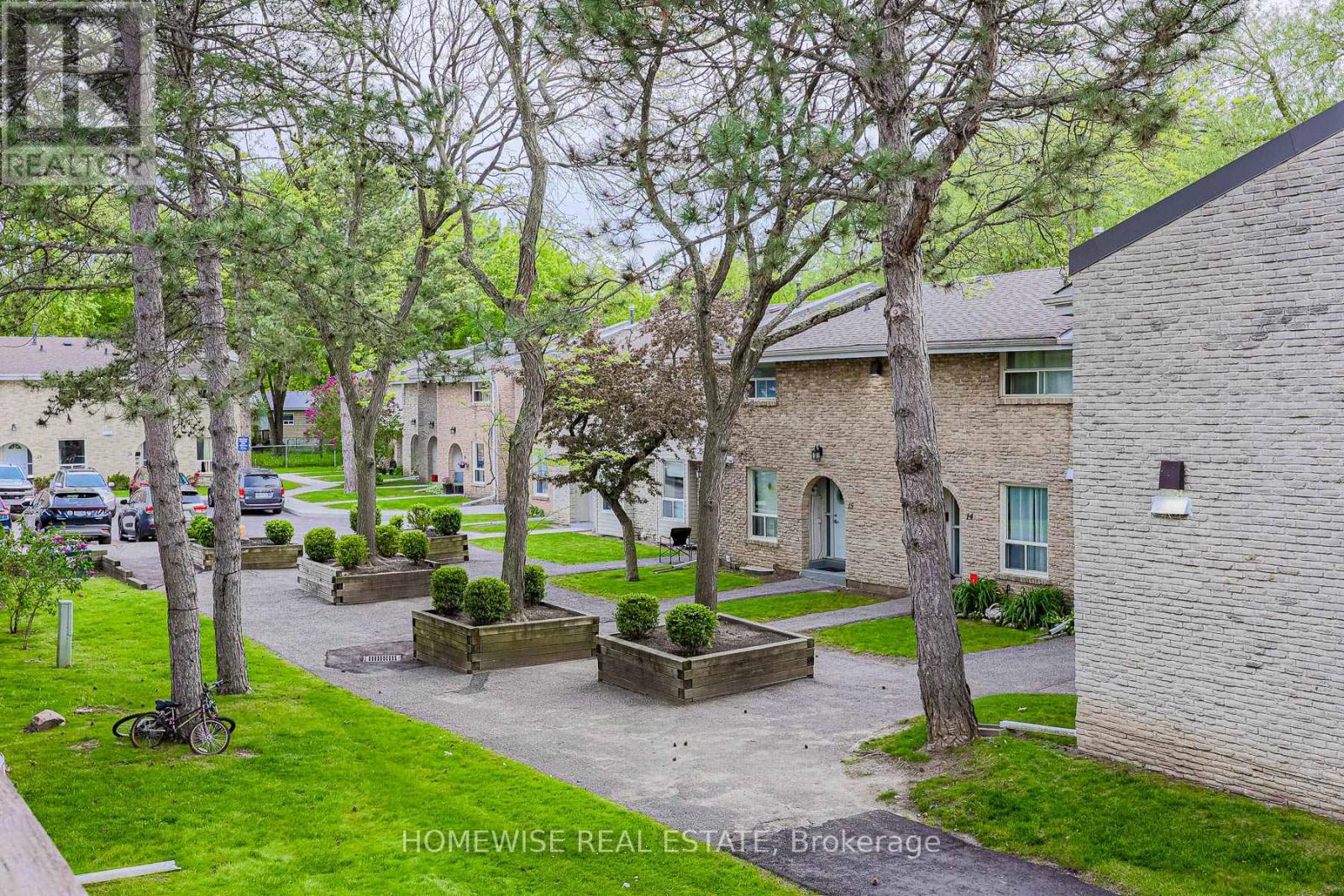 A real estate photo of a residential area with houses and greenery.
