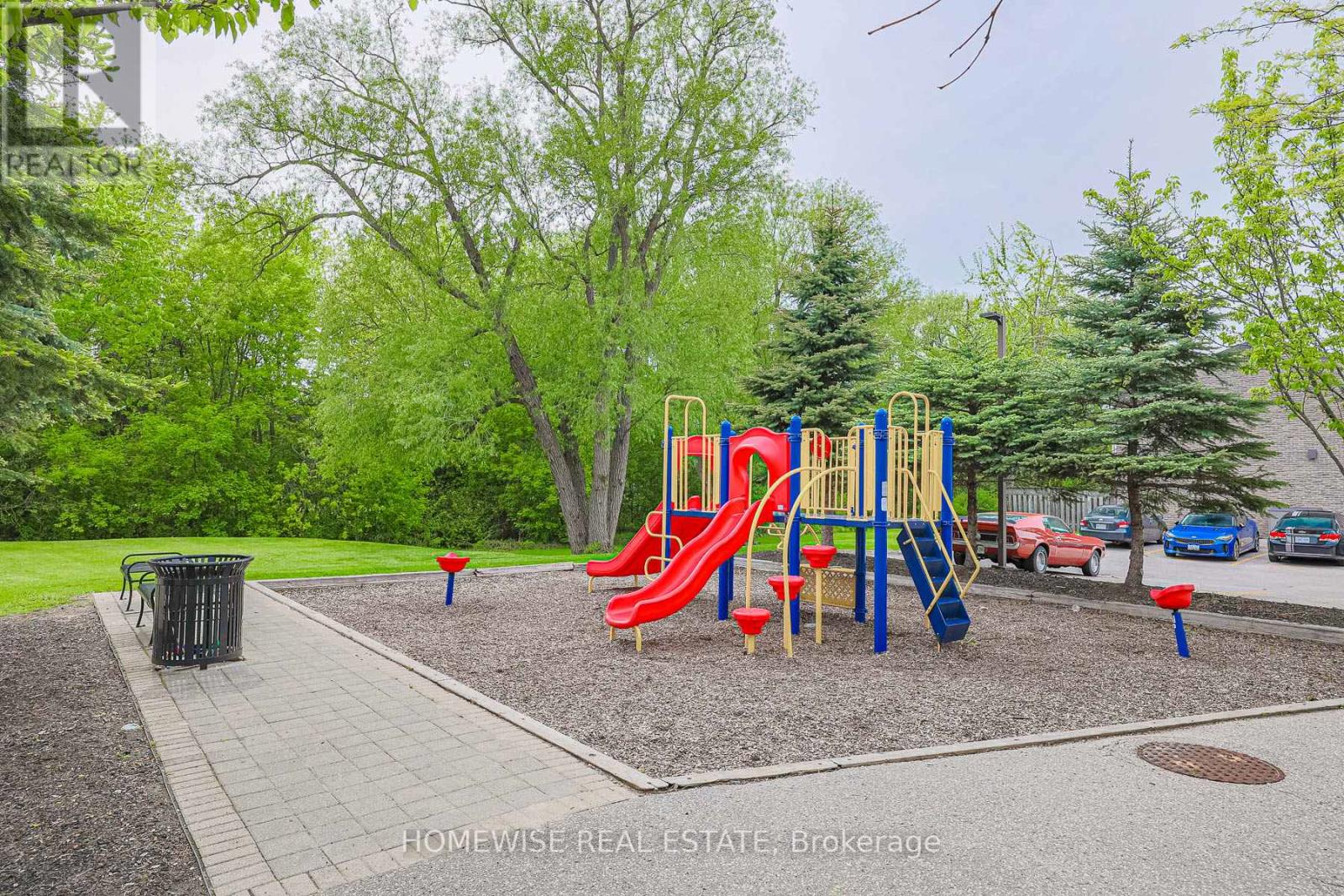 A playground with a red slide and a blue slide.