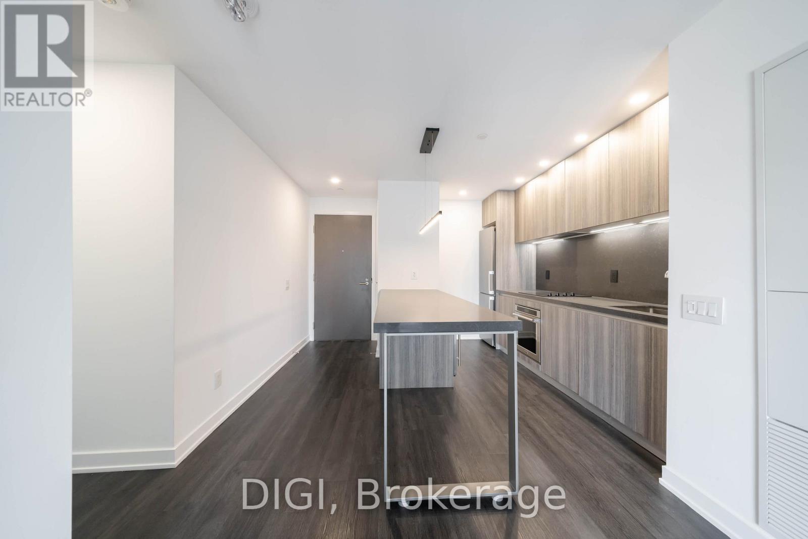 A modern kitchen with a dining table and a sink.