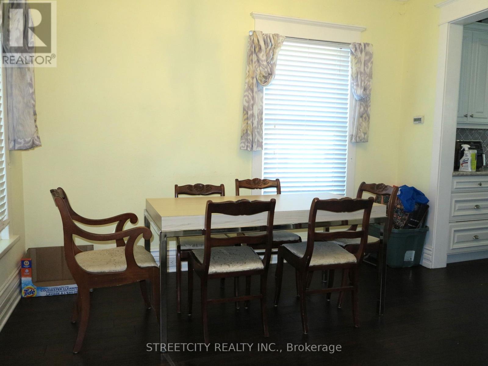 A dining room with a table and chairs.
