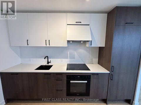 A kitchen with a white countertop and dark wood cabinets.