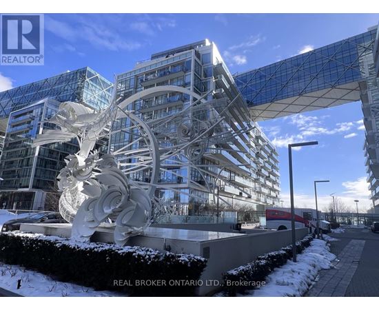 A large white sculpture in front of a glass building with the words "REAL BROKER ONTARIO LTD." on the bottom left.