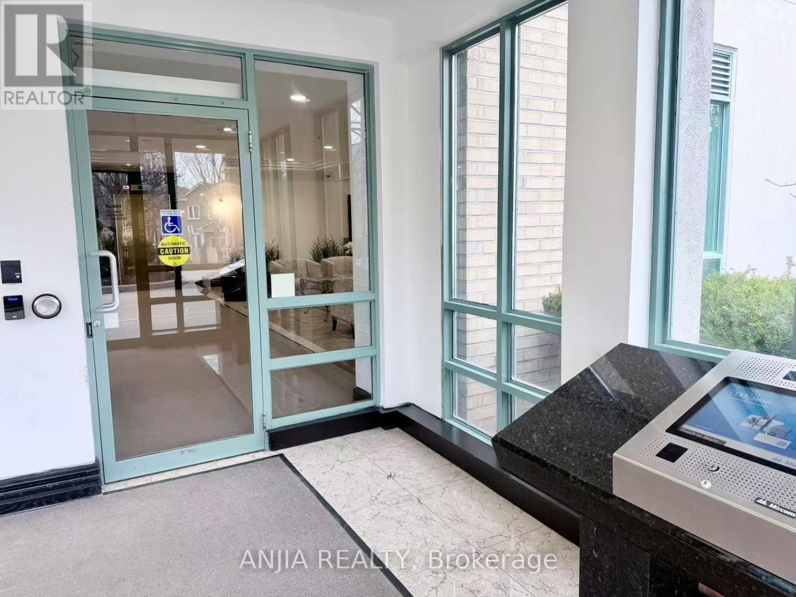 A glass door with a sign on it and a black counter in front of it.