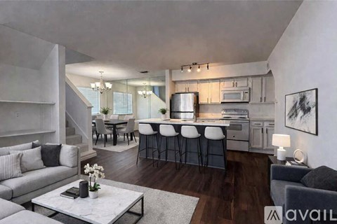 A modern kitchen with a breakfast bar and a dining table with chairs.