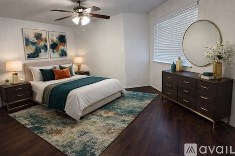 A bedroom with a large bed and a dresser with a mirror.
