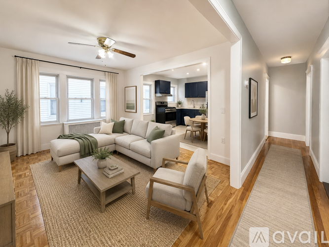A living room with a white couch, a wooden coffee table, and a ceiling fan.