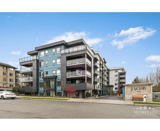 A modern apartment building named Jacob with a clear blue sky in the background.