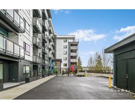 A street view of a residential area with apartment buildings on both sides.