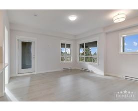 A spacious room with a large window and a door leading to another room.