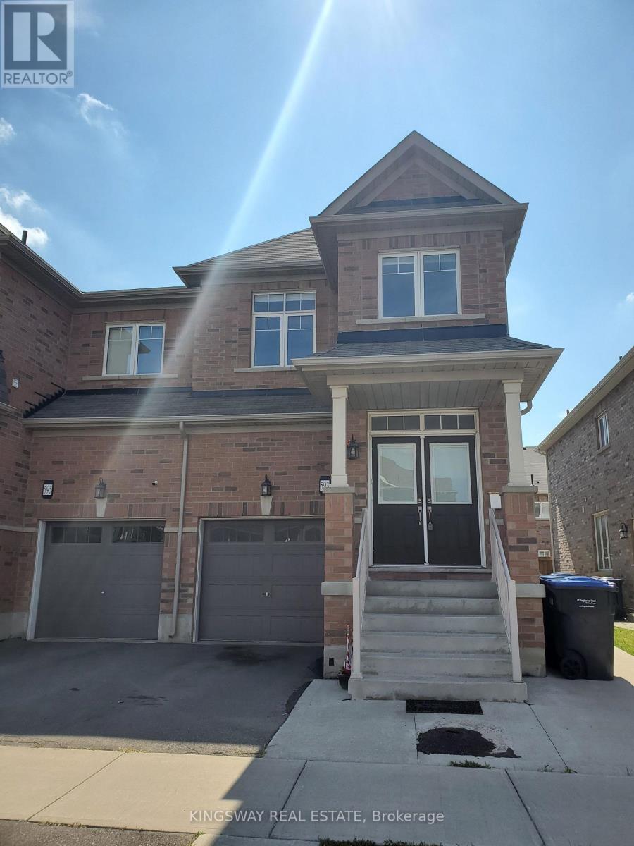 A house with a garage and a trash can in front of it.