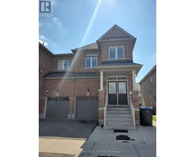 A house with a garage and a trash can in front of it.