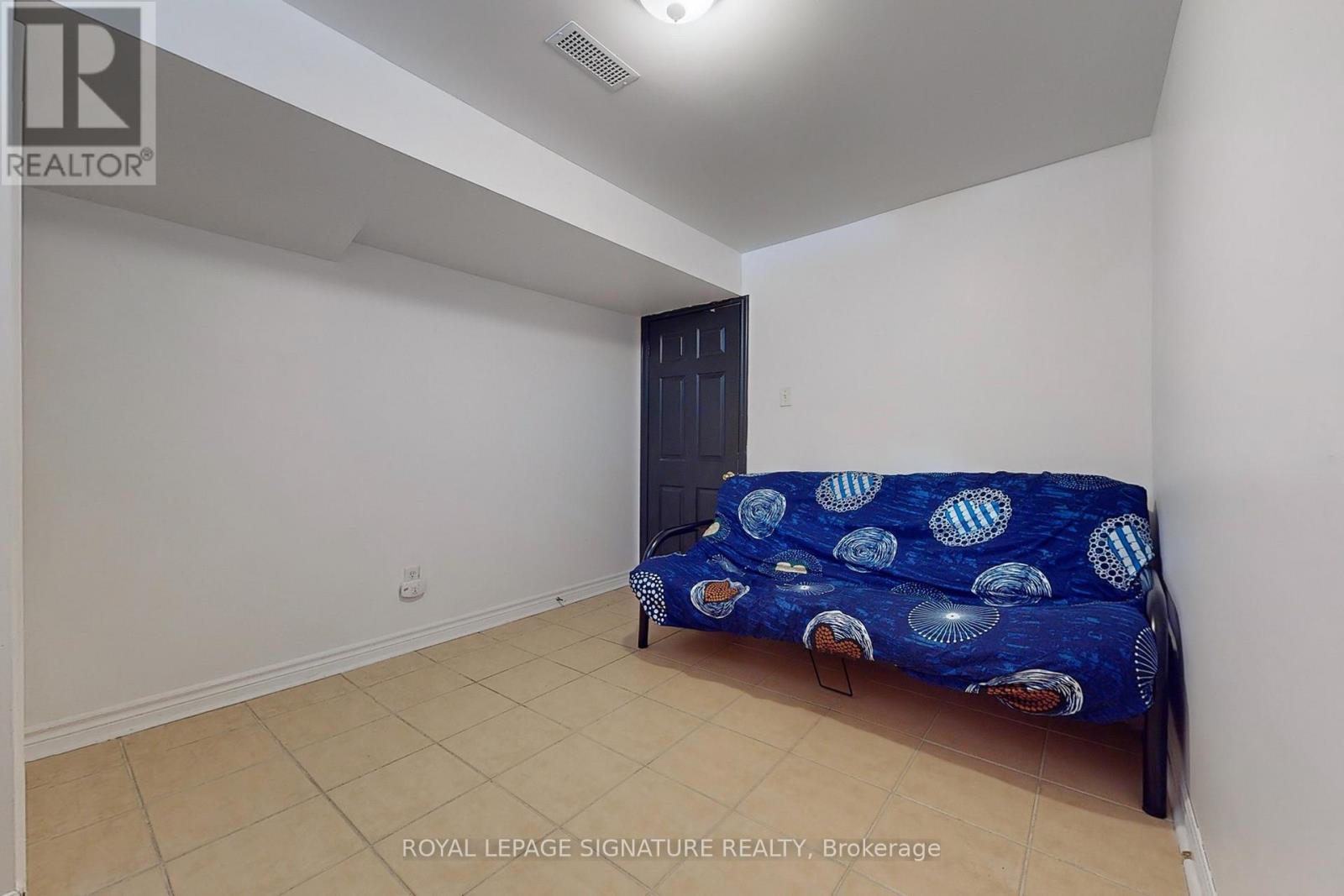 A bedroom with a bed and a wardrobe.