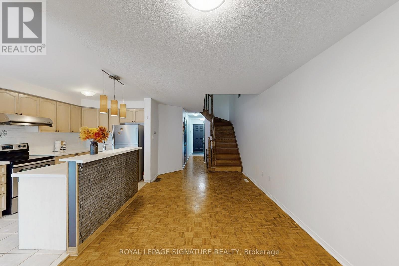 A kitchen with a white counter and a stove top oven.