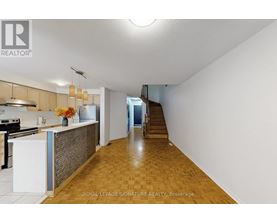 A kitchen with a white counter and a stove top oven.