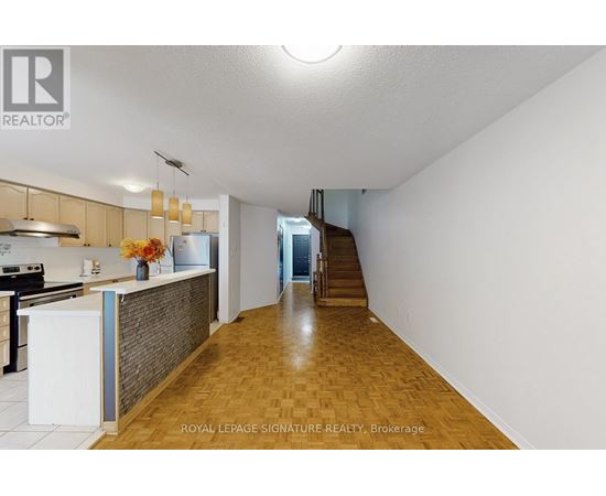 A kitchen with a white counter and a stove top oven.