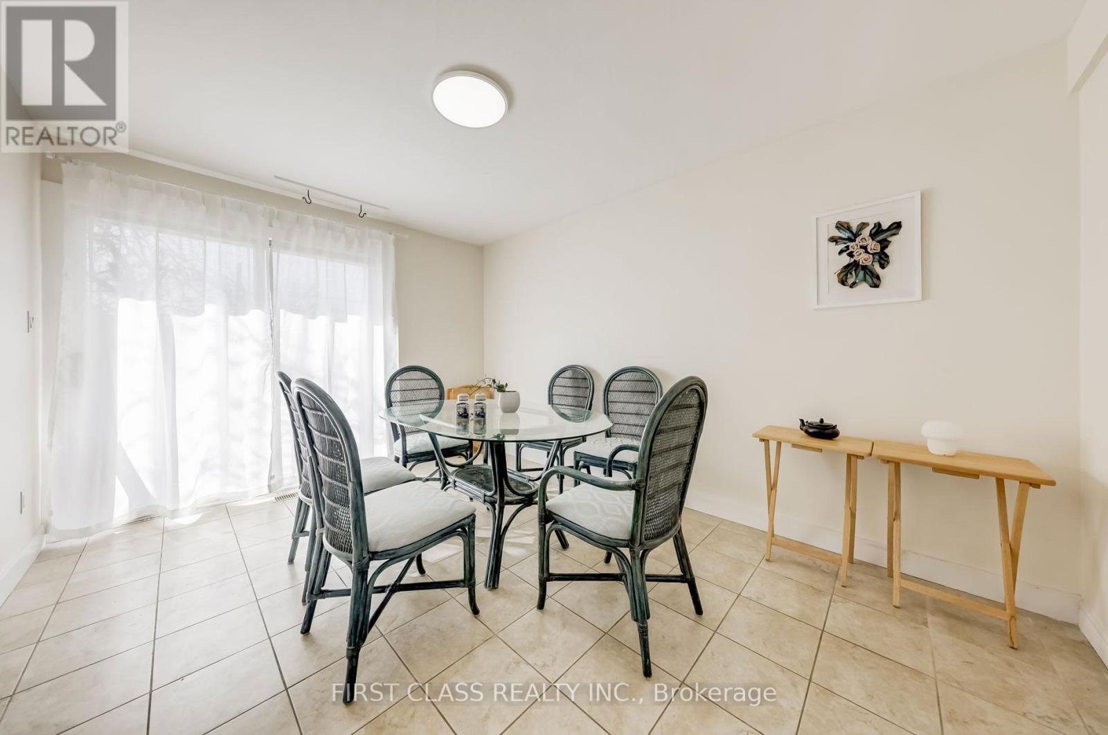 A dining room with a table set for six.