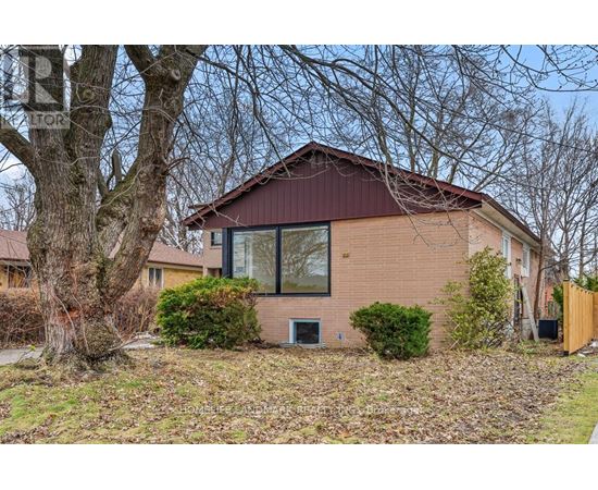A house with a brown roof and a tree in front.