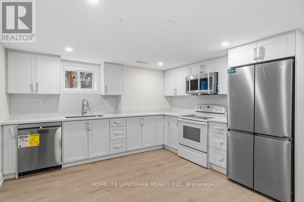 A kitchen with white cabinets and stainless steel appliances.