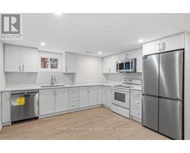 A kitchen with white cabinets and stainless steel appliances.
