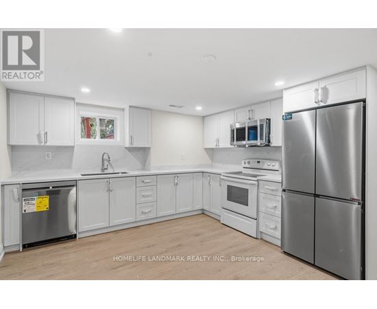 A kitchen with white cabinets and stainless steel appliances.
