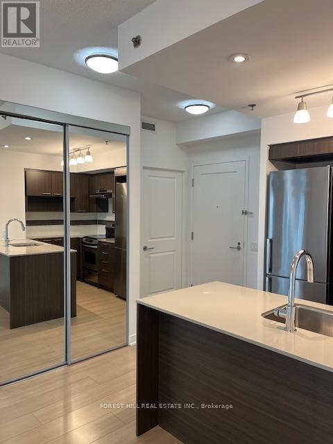 A modern kitchen with a sink and a refrigerator.