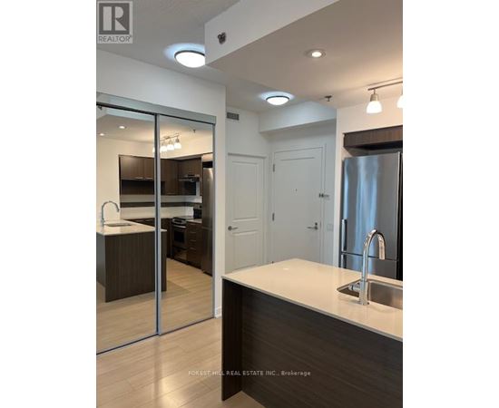 A modern kitchen with a sink and a refrigerator.